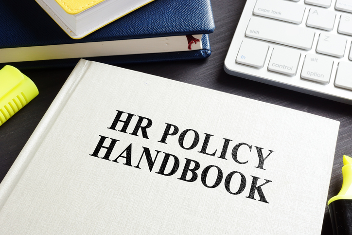 HR Policy handbook on an office desk